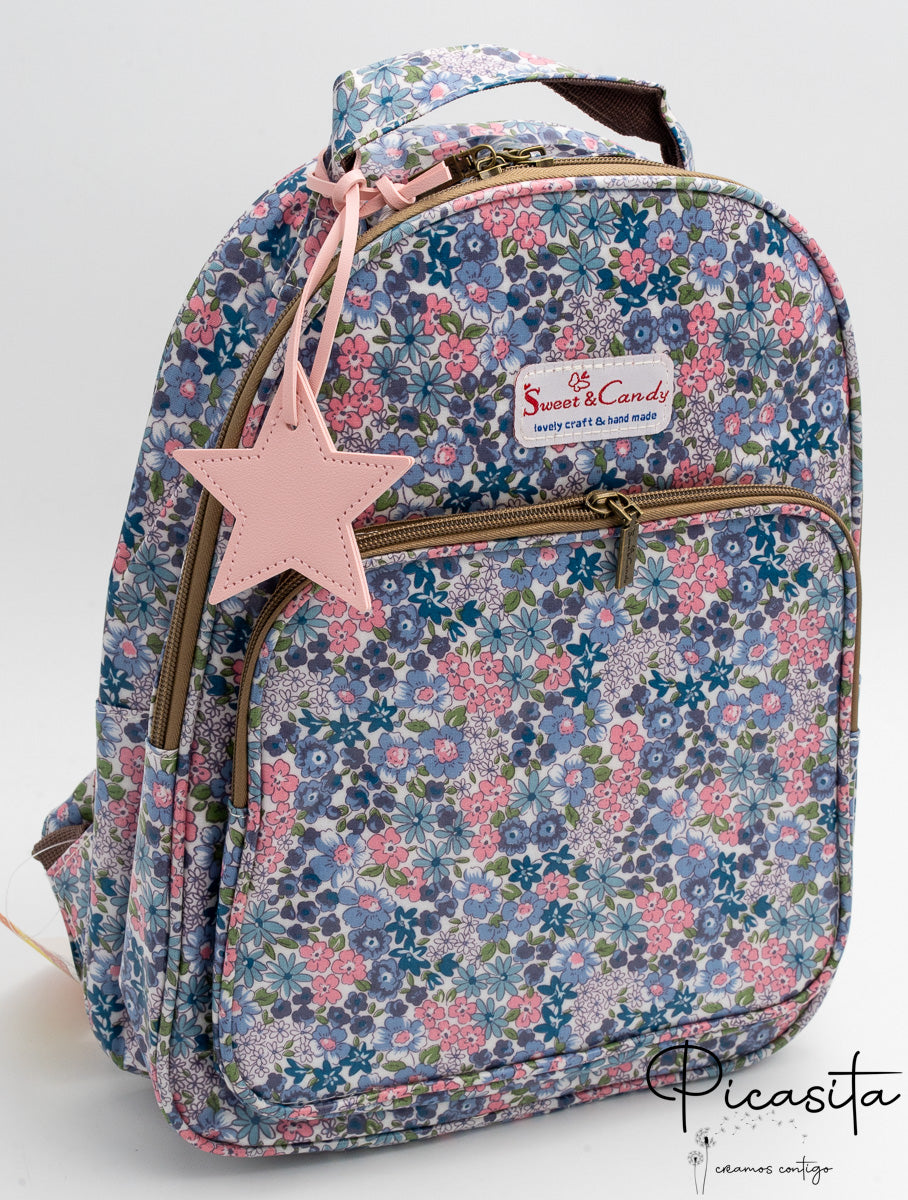 Mochila con estampado floral en tonos azules y rosas con estrella decorativa rosa.