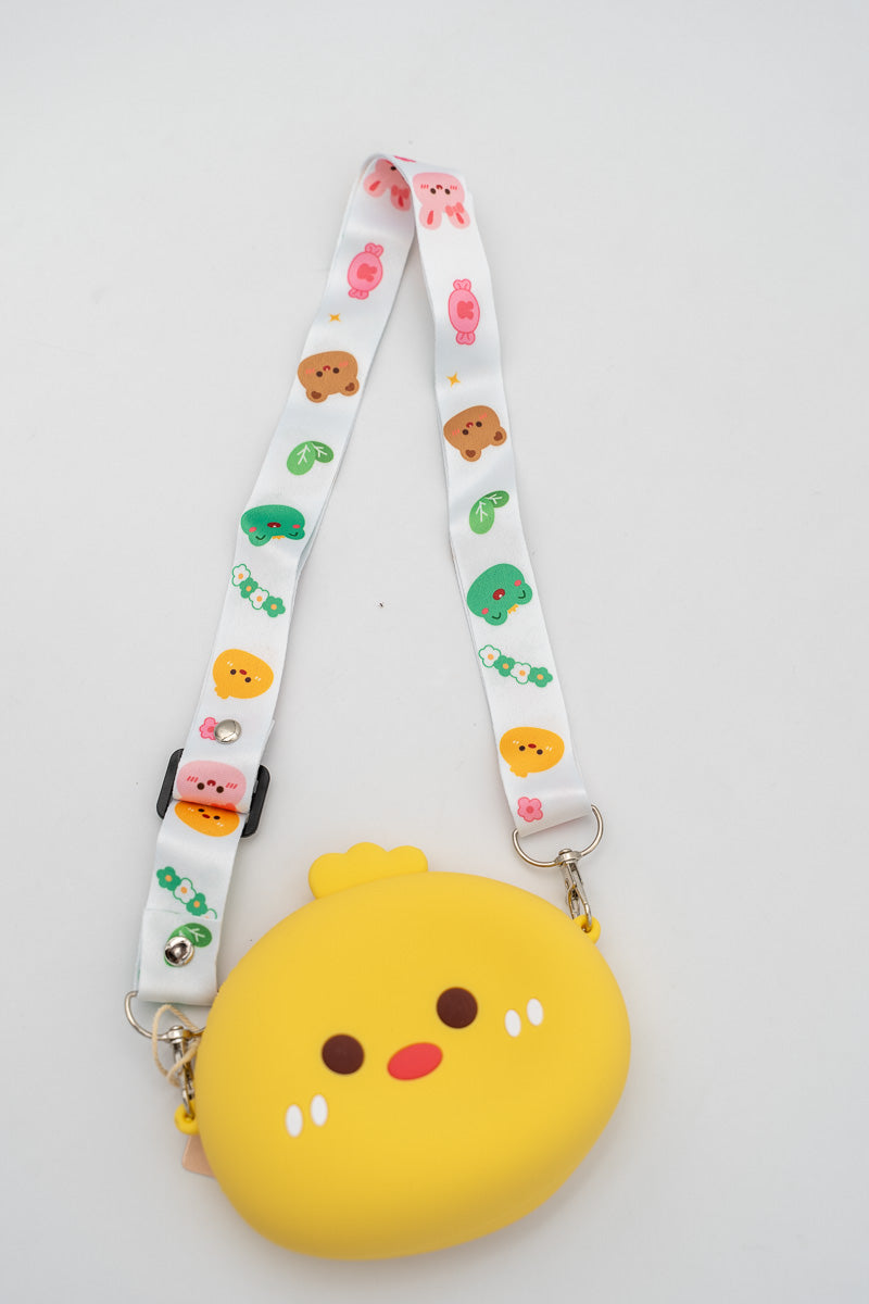 Bolso de silicona amarillo con forma de pollito y detalles faciales sencillos.